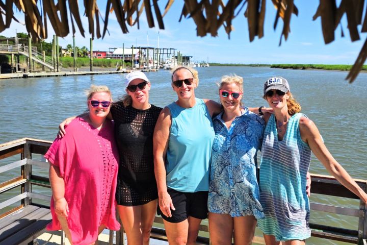 a group of people standing in front of a body of water