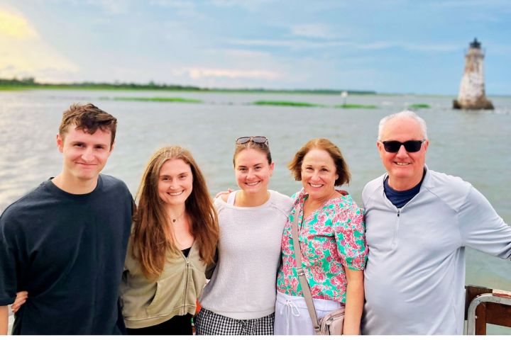 a couple of people that are standing in front of a body of water