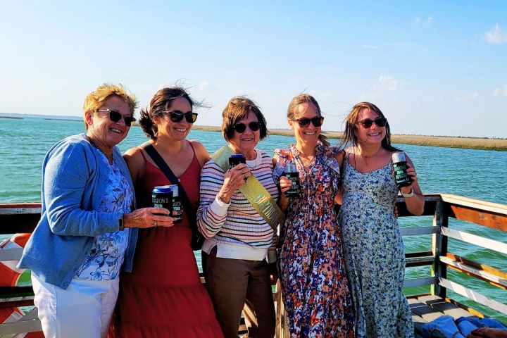 a woman standing next to a body of water