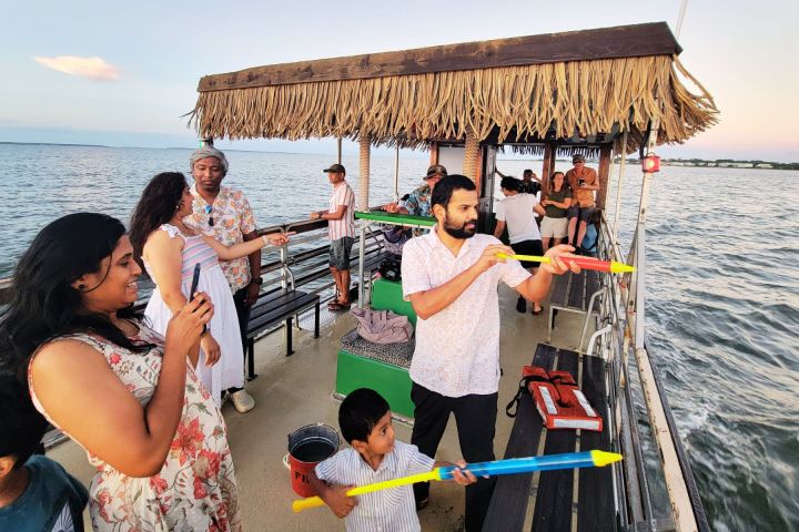 a group of people standing next to a body of water