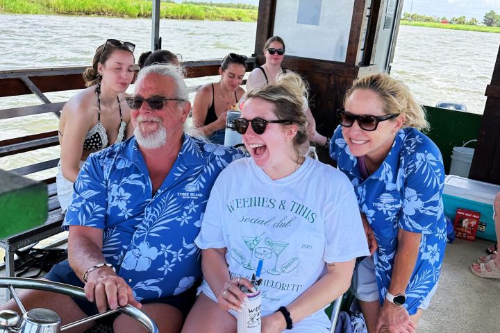 a group of people sitting at a dock