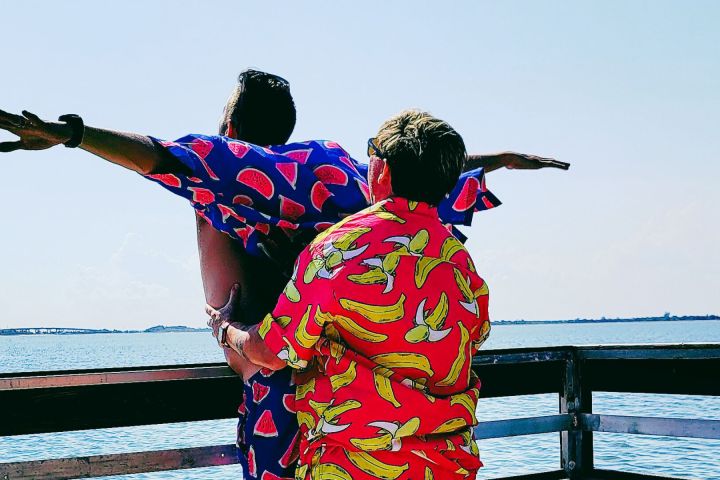 a person sitting on a bench next to a body of water