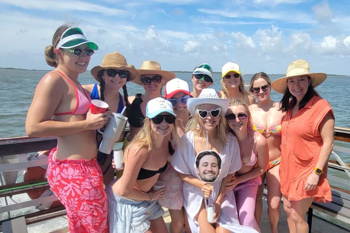 a group of people standing next to a body of water