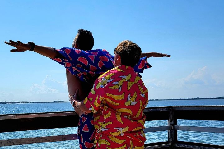 a person sitting on a bench next to a body of water